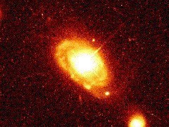 Figure 2. Image showing the luminous quasar-like core of spiral galaxy PG 0052+25. Taken with the Hubble Space Telescope.  (Courtesy of J. Bahcall and NASA)